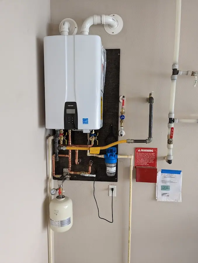 Professional plumber installing copper piping in a St. Peters home